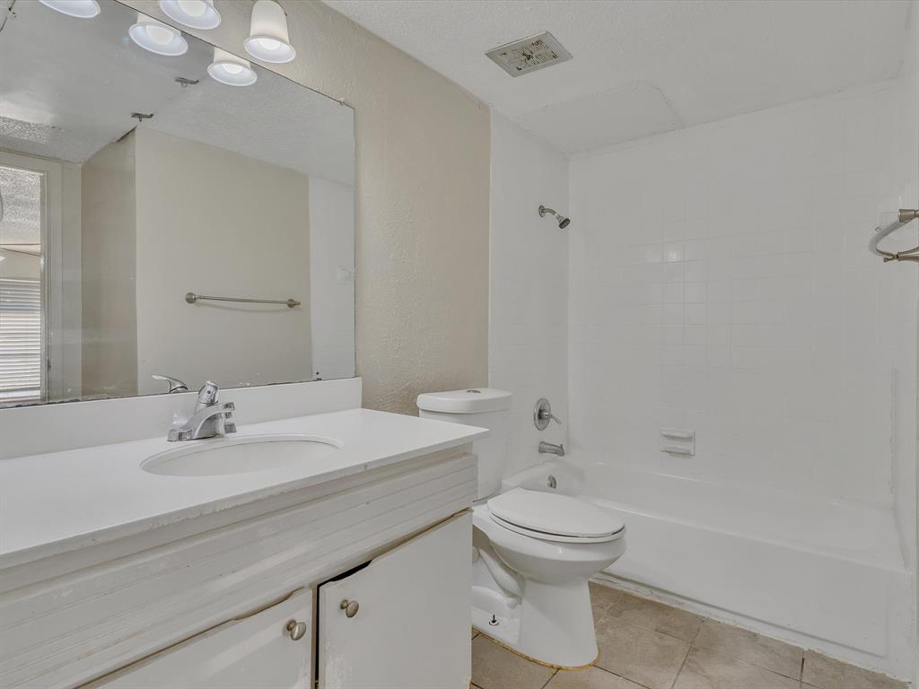 5053 Ridglea Lane, Unit 911 Fort Worth, TX 76116 - Photo 7 of 16 a bathroom with a sink a toilet and shower