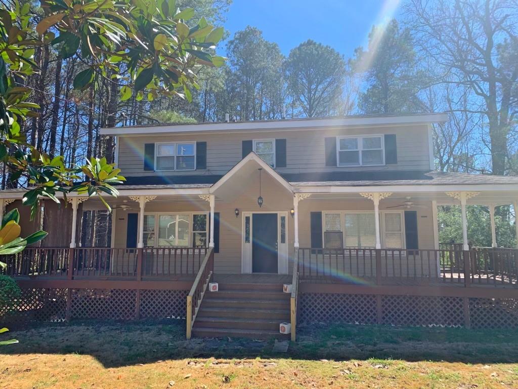 2178 Mt Vernon Road Lithia Springs, GA 30122 - Photo 1 of 1 a front view of a house with a garden