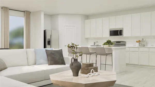 a living room with furniture and a dining table