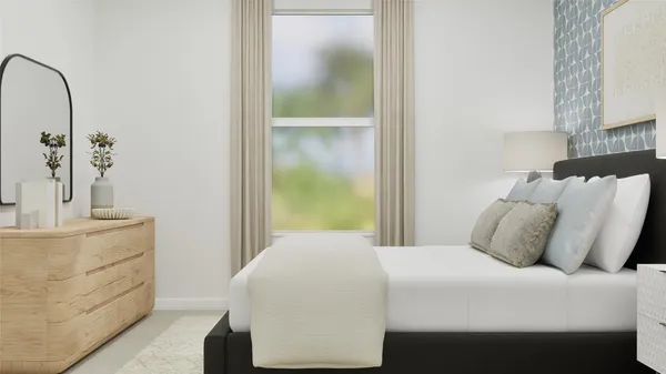 a bedroom with a bed and a mirror