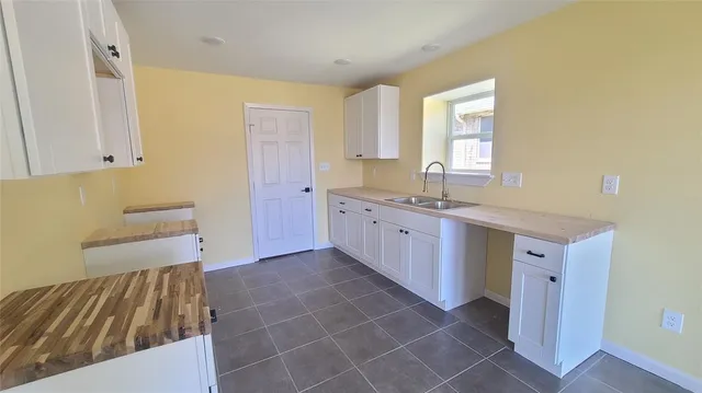 a spacious bathroom with a mirror and a sink