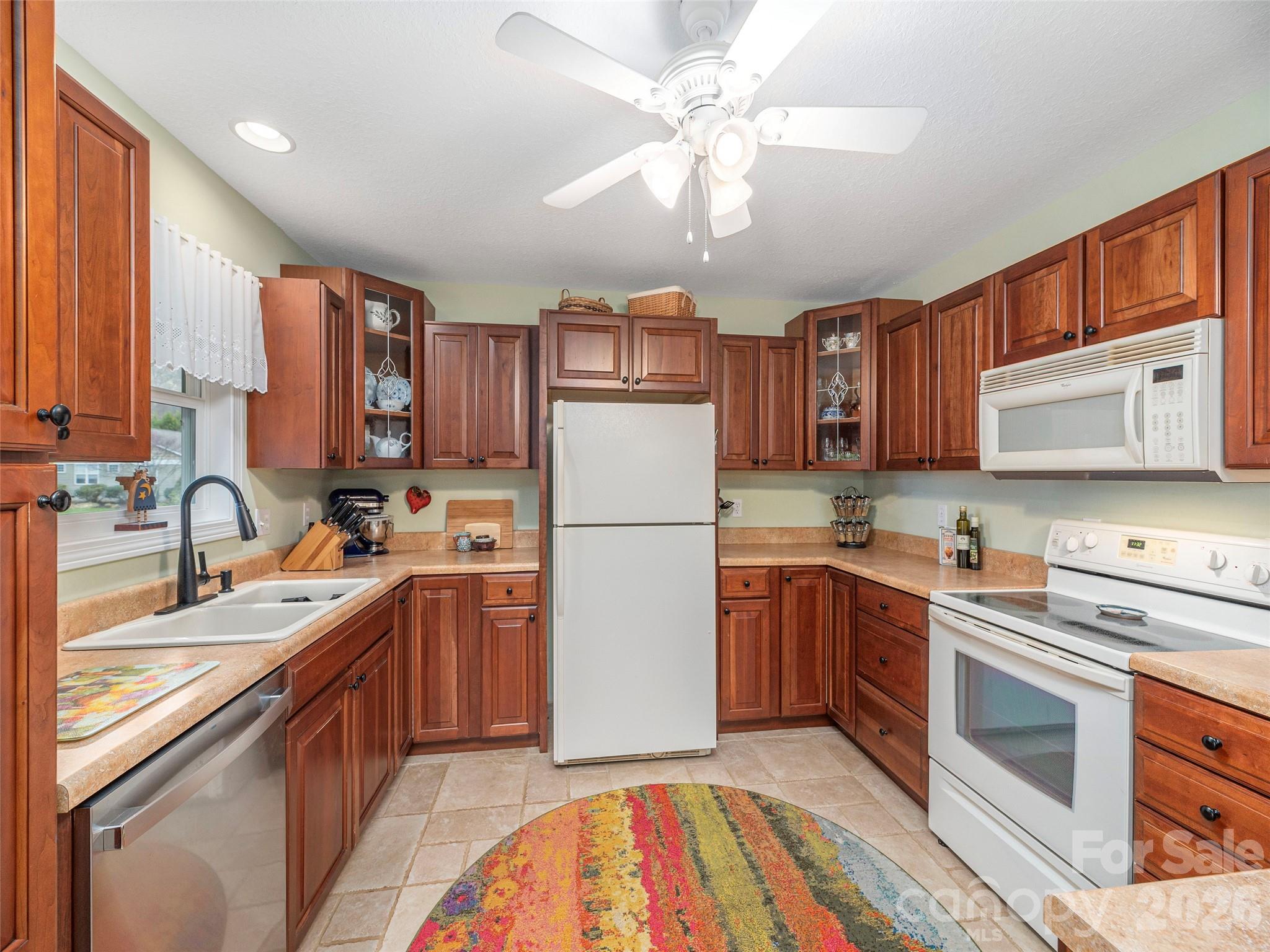 22 Cottage Loop Waynesville, NC 28785 - Photo 11 of 26 a kitchen with stainless steel appliances granite countertop a sink stove and refrigerator
