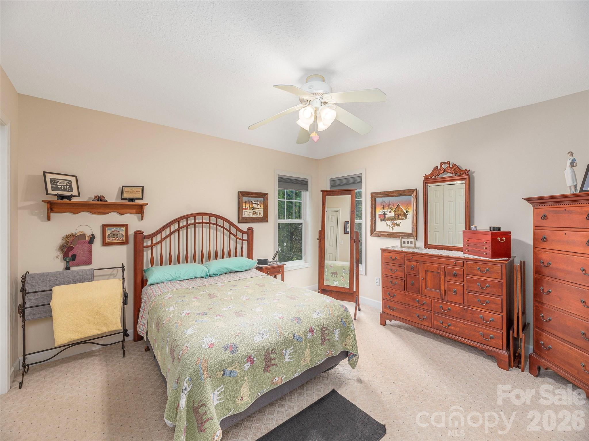 22 Cottage Loop Waynesville, NC 28785 - Photo 13 of 26 a bedroom with a bed and a chandelier