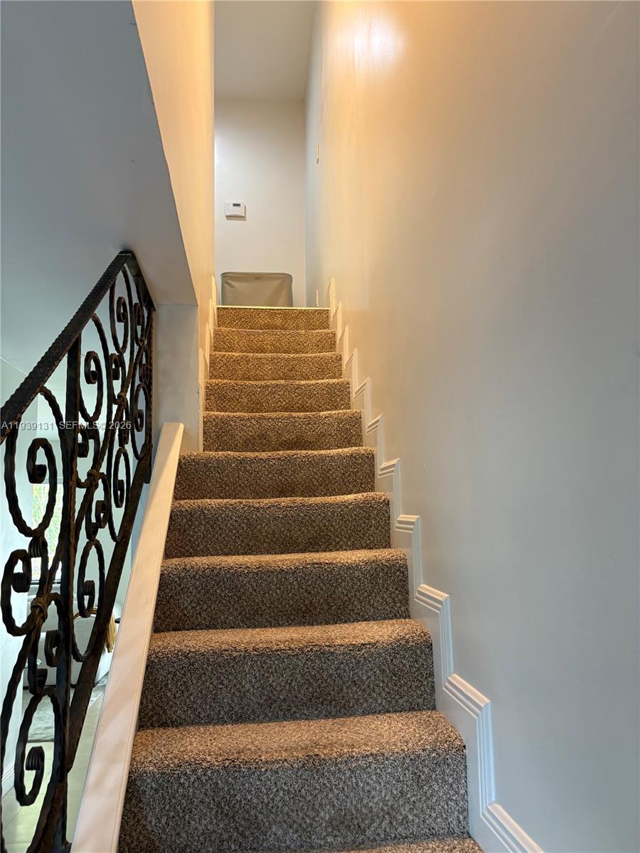5555 Ludlam Road, Unit 25 South Miami, FL 33155 - Photo 14 of 27 a view of staircase with white walls
