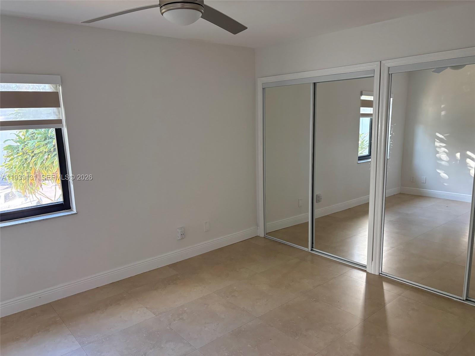 5555 Ludlam Road, Unit 25 South Miami, FL 33155 - Photo 18 of 27 an empty room with windows and closet