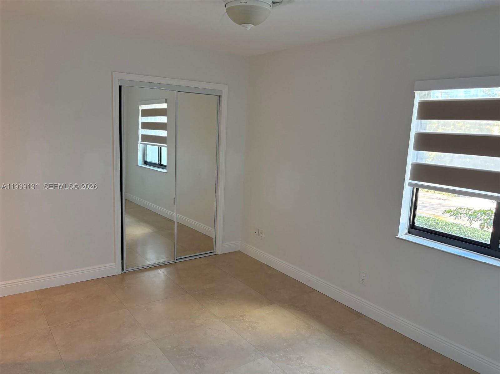 5555 Ludlam Road, Unit 25 South Miami, FL 33155 - Photo 21 of 27 an empty room with windows