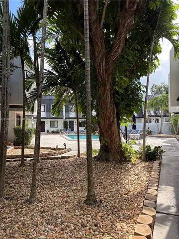 a view of outdoor space with swimming pool and trees