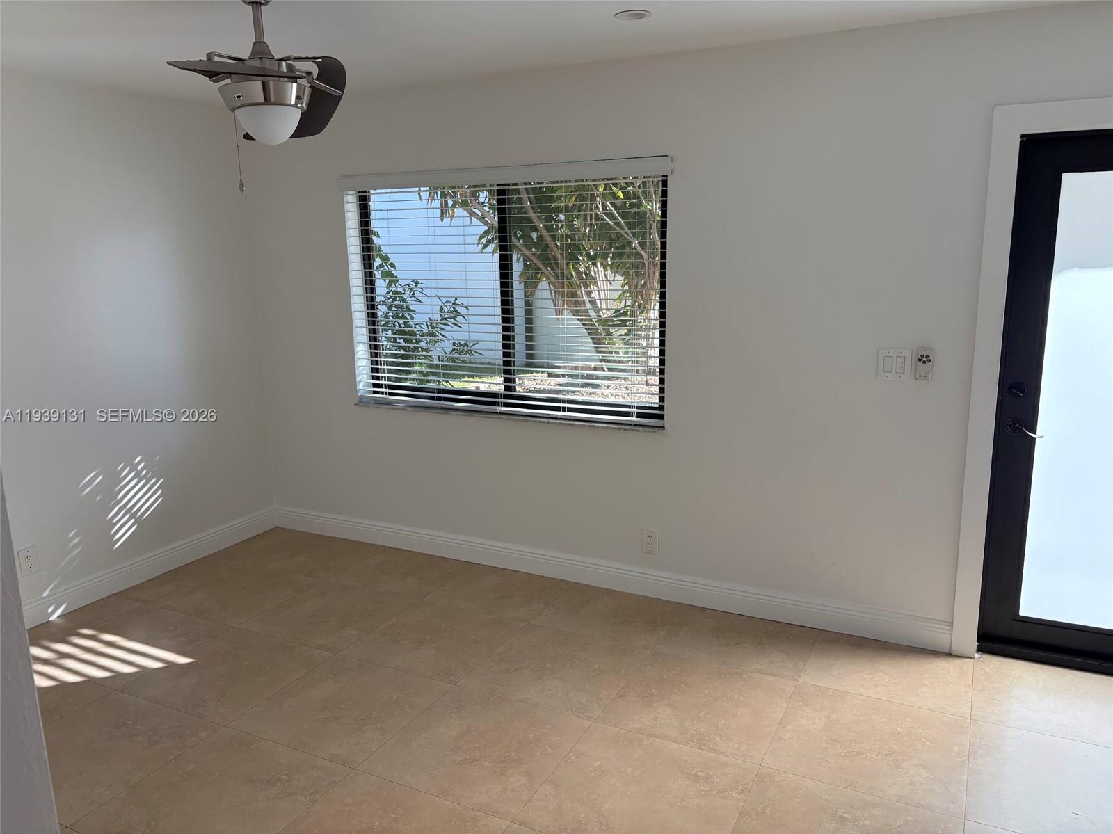 5555 Ludlam Road, Unit 25 South Miami, FL 33155 - Photo 4 of 27 an empty room with windows
