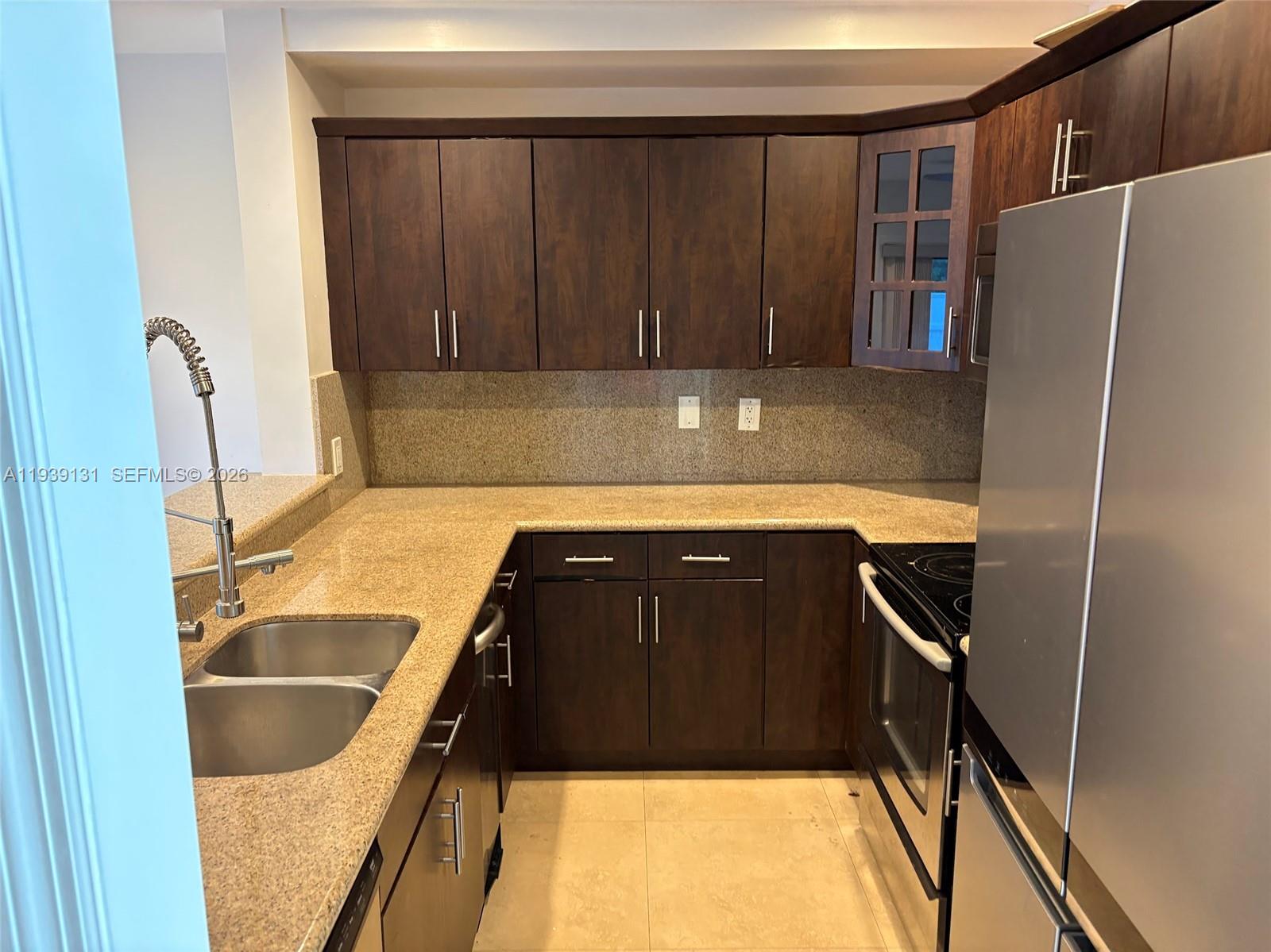 5555 Ludlam Road, Unit 25 South Miami, FL 33155 - Photo 6 of 27 a kitchen with a sink and a refrigerator