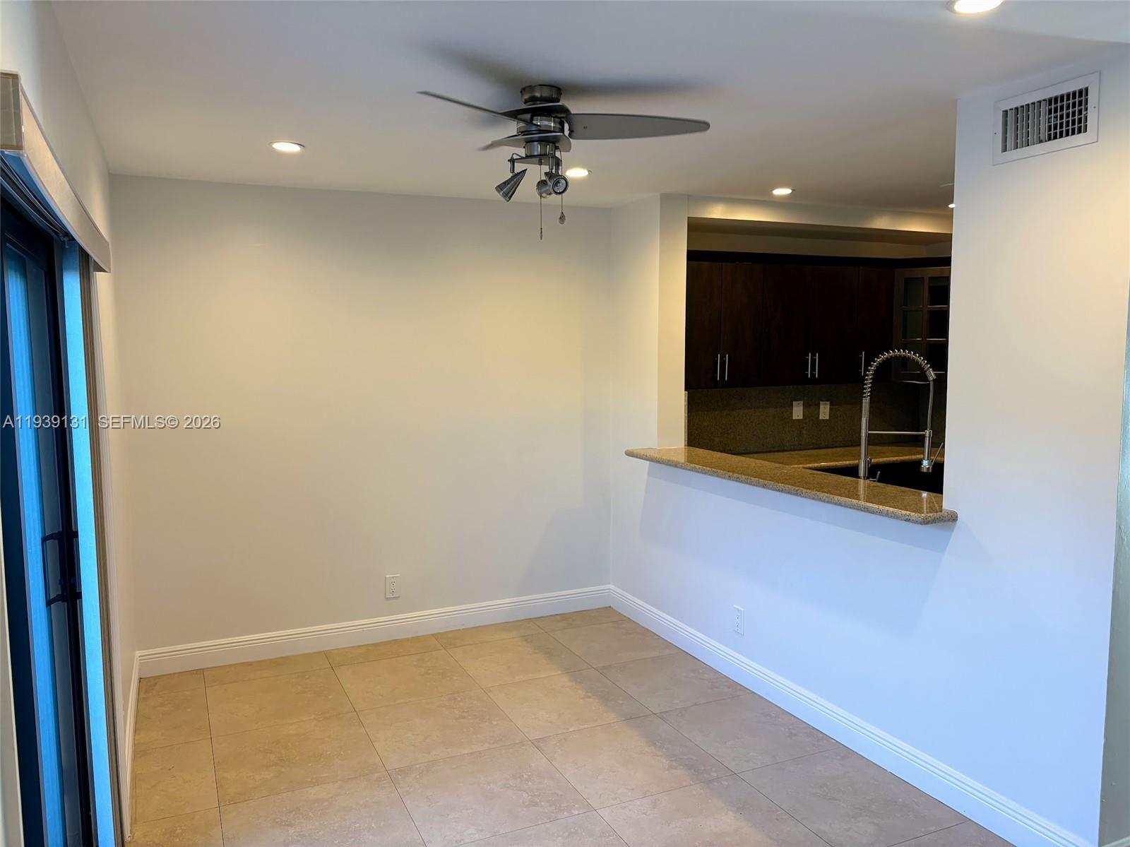 5555 Ludlam Road, Unit 25 South Miami, FL 33155 - Photo 9 of 27 wooden floor in an empty room with a window