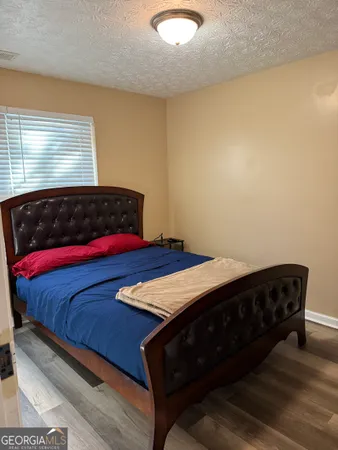 a bed sitting in a bedroom next to a window