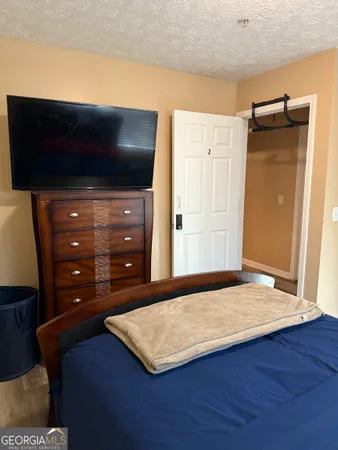 a view of a livingroom with wooden floor and cabinet