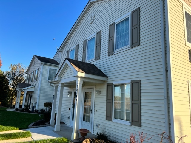 1526 McClure Road, Unit 1526 Aurora, IL 60505 - Photo 1 of 12 a front view of a house with a yard
