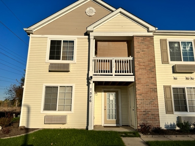 1526 McClure Road, Unit 1526 Aurora, IL 60505 - Photo 2 of 12 a front view of a house with a yard