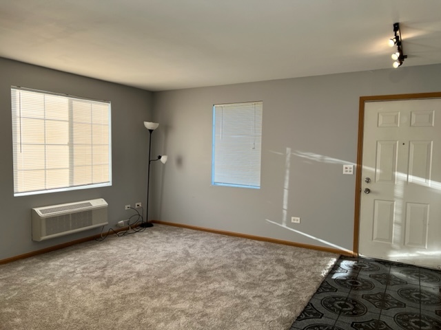1526 McClure Road, Unit 1526 Aurora, IL 60505 - Photo 3 of 12 an empty room with windows
