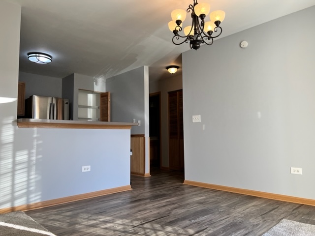 1526 McClure Road, Unit 1526 Aurora, IL 60505 - Photo 4 of 12 a view of a kitchen with a sink cabinet and a chandelier