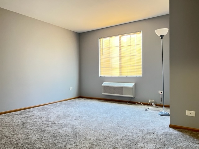 1526 McClure Road, Unit 1526 Aurora, IL 60505 - Photo 6 of 12 an empty room with windows