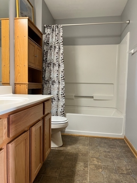 1526 McClure Road, Unit 1526 Aurora, IL 60505 - Photo 7 of 12 a bathroom with a sink a toilet and shower