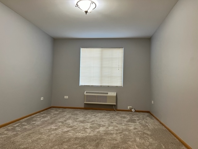 1526 McClure Road, Unit 1526 Aurora, IL 60505 - Photo 8 of 12 an empty room with a empty space and windows