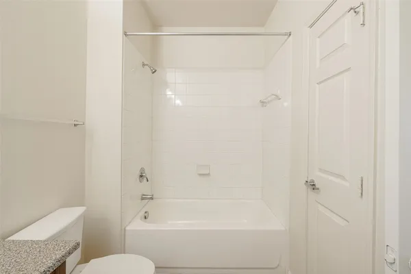a bathroom with a shower and a toilet
