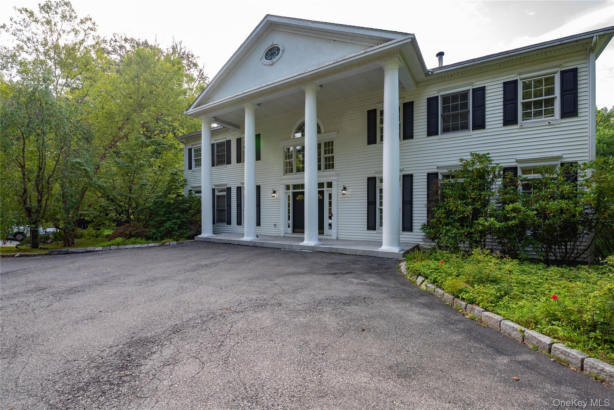 59 Orchard Hill Road Katonah, NY 10536 - Photo 4 of 27 front view of a house with a yard