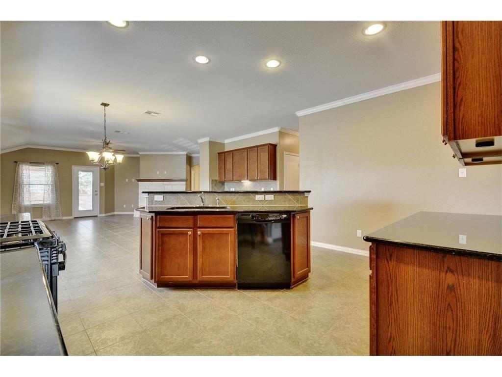 2109 Granite Springs Road Leander, TX 78641 - Photo 8 of 30 A functional kitchen island provides extra counter space and a convenient gathering spot.