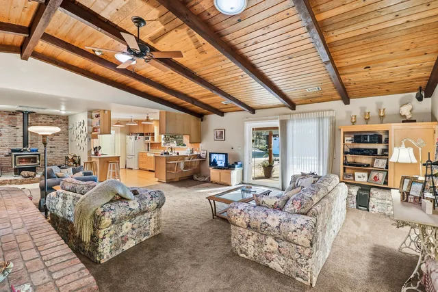 a bedroom with a bed a couch and potted plant