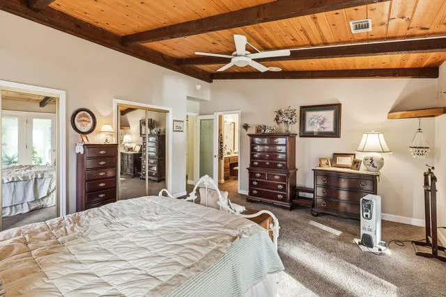 a view of a patio with table and chairs under an umbrella