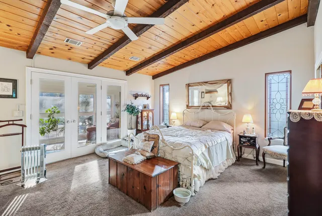 a view of swimming pool with outdoor seating and trees in the background