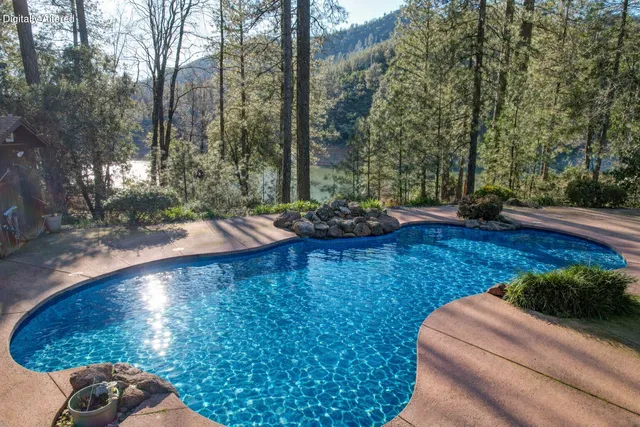 a front view of a house with a yard and potted plants