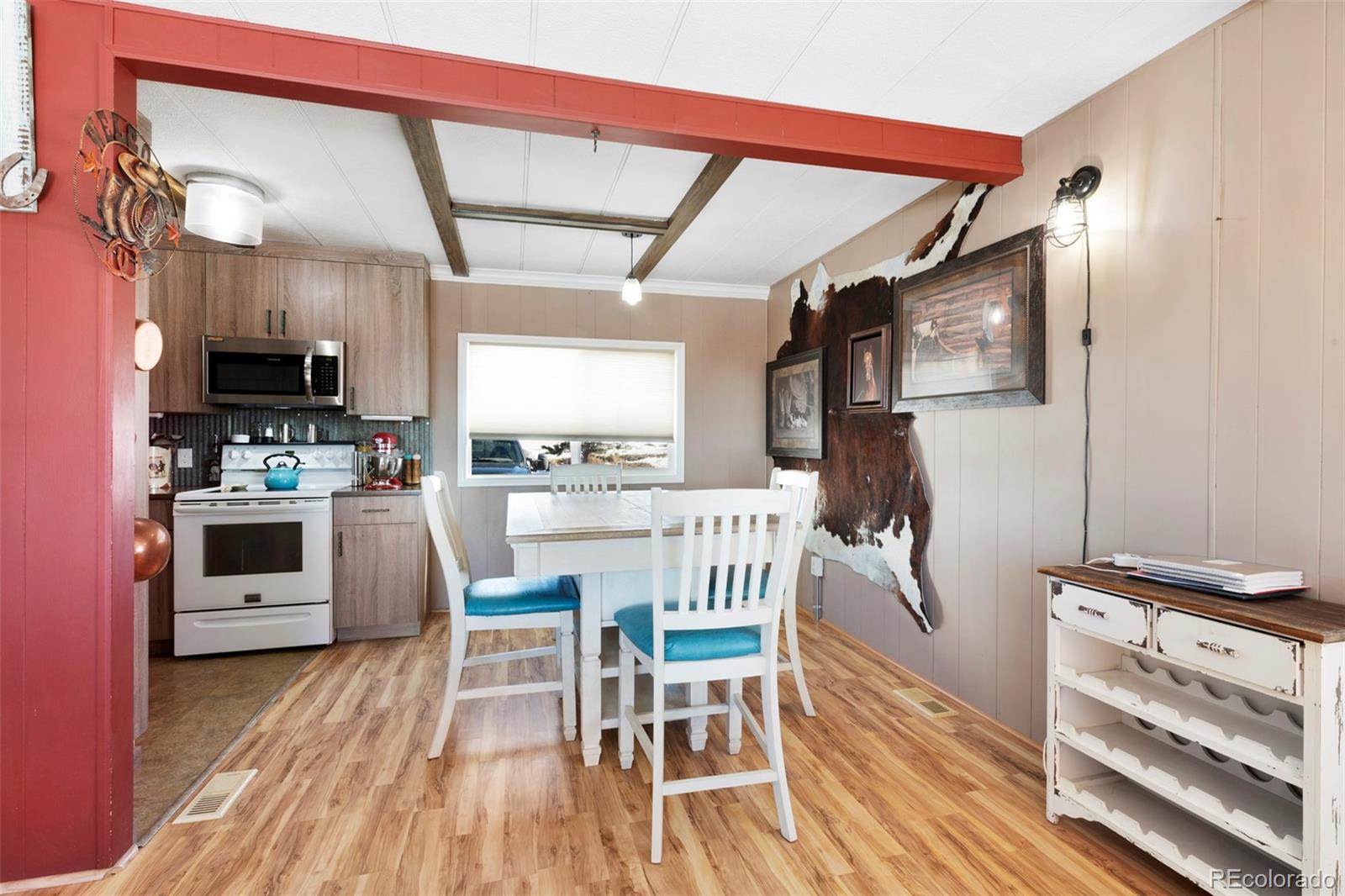 1382 Flintwood Road Franktown, CO 80116 - Photo 12 of 40 a kitchen with stainless steel appliances a stove a sink dishwasher a refrigerator with a dining table and chairs