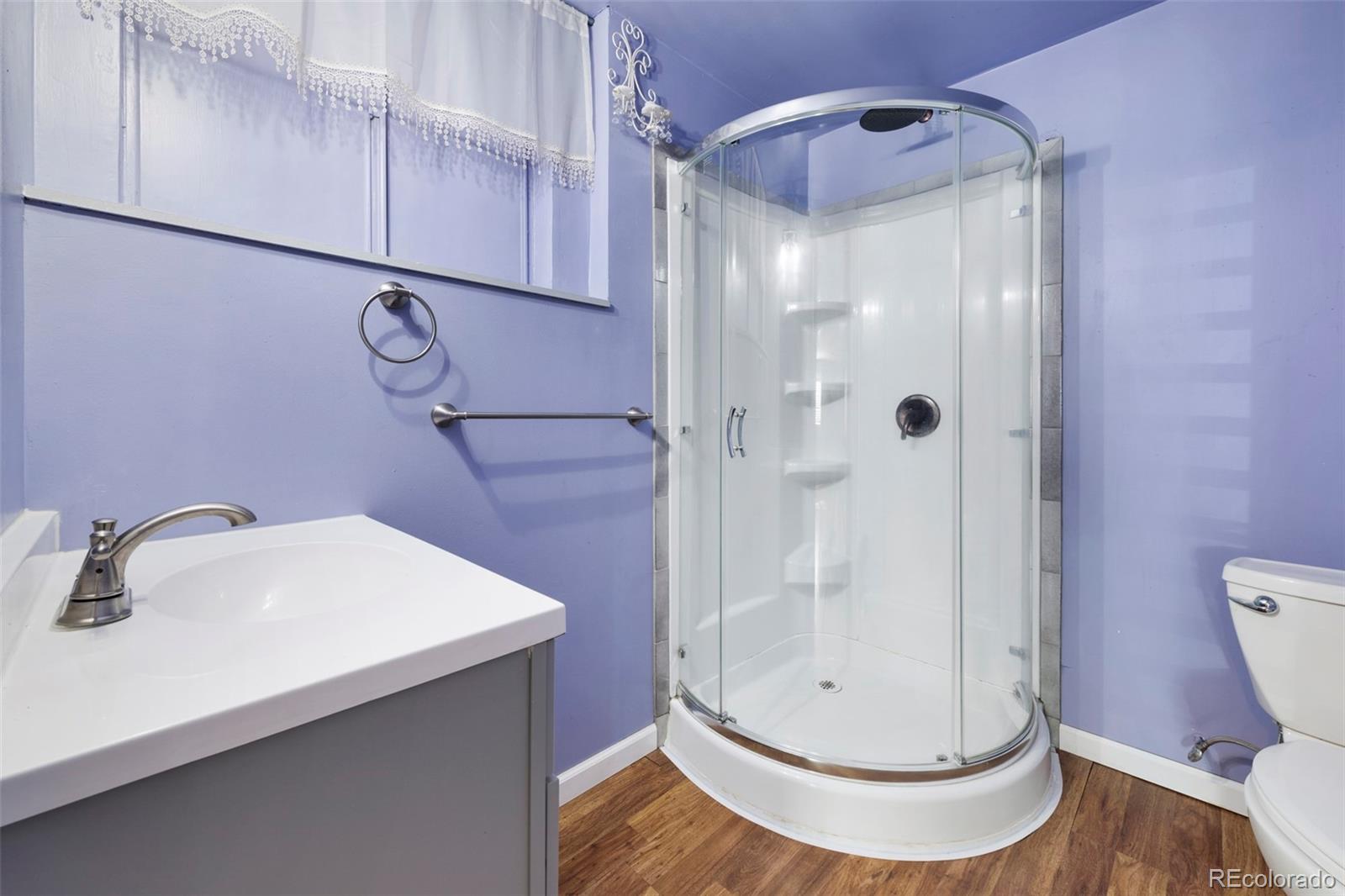 1382 Flintwood Road Franktown, CO 80116 - Photo 22 of 40 a bathroom with a sink a toilet and shower