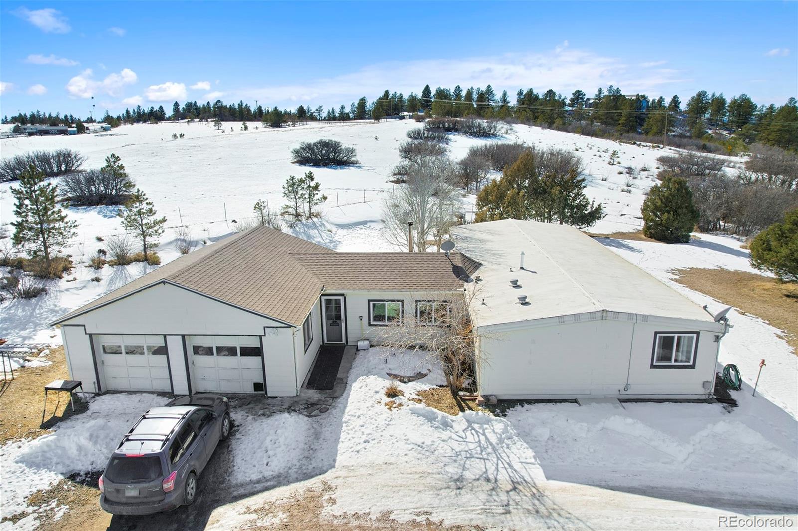 1382 Flintwood Road Franktown, CO 80116 - Photo 23 of 40 a view of a house with outdoor space and lake view