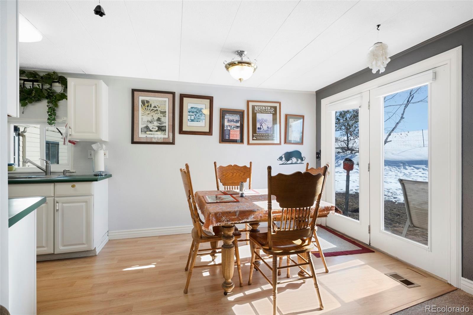 1382 Flintwood Road Franktown, CO 80116 - Photo 27 of 40 a view of a dining room with furniture and wooden floor