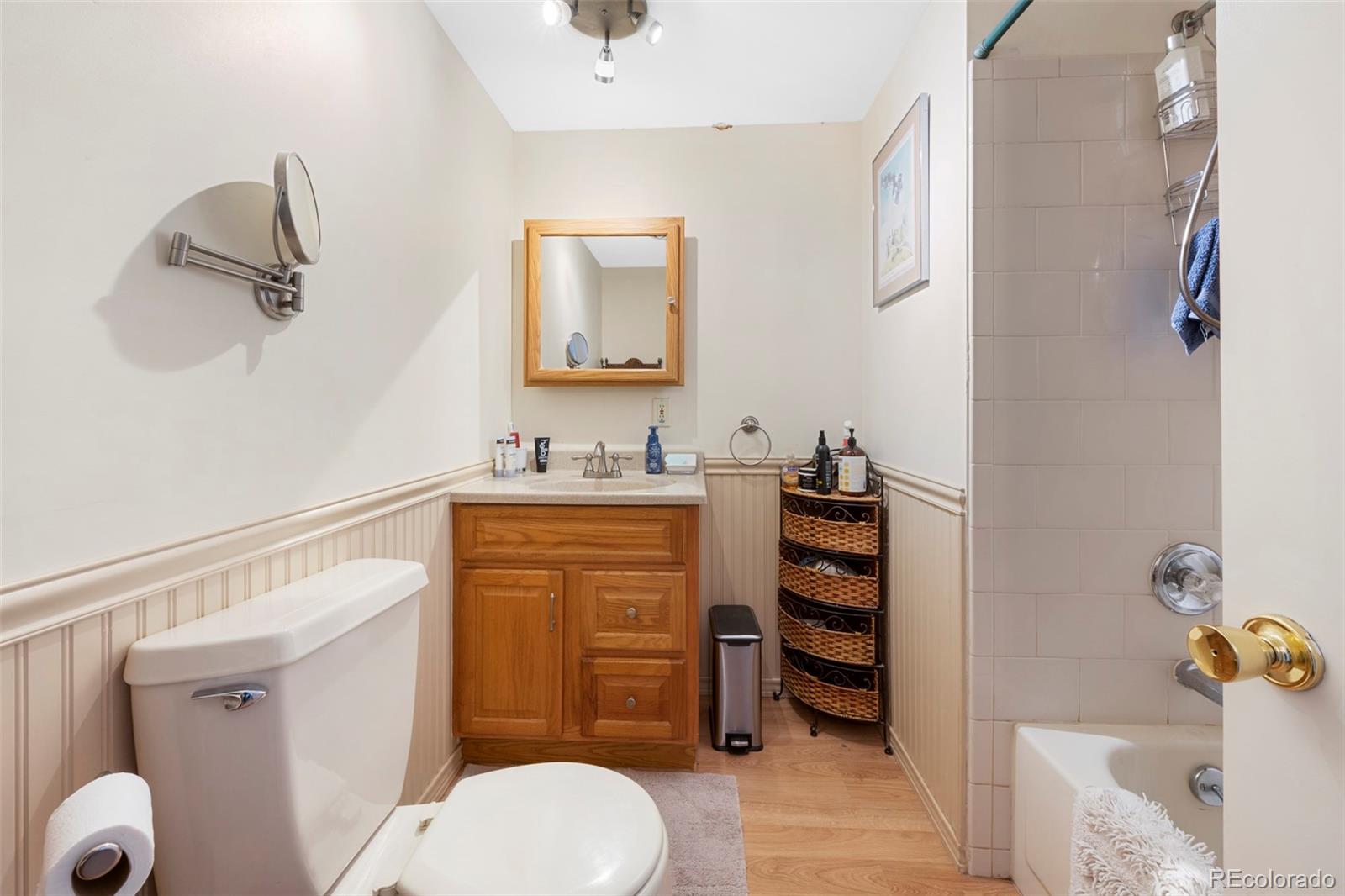 1382 Flintwood Road Franktown, CO 80116 - Photo 29 of 40 a bathroom with a toilet sink and mirror