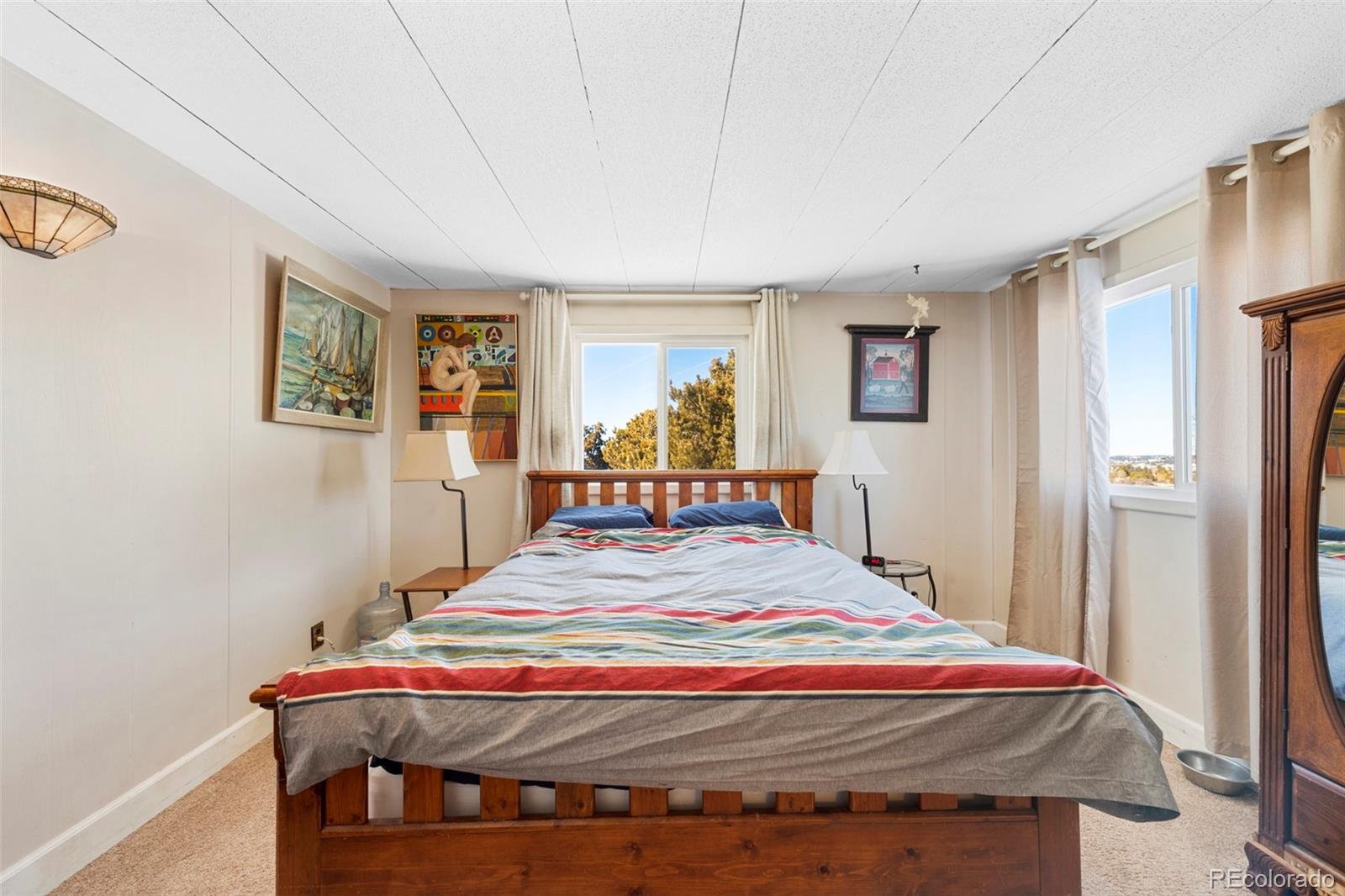 1382 Flintwood Road Franktown, CO 80116 - Photo 30 of 40 a bed sitting in a bedroom next to a window