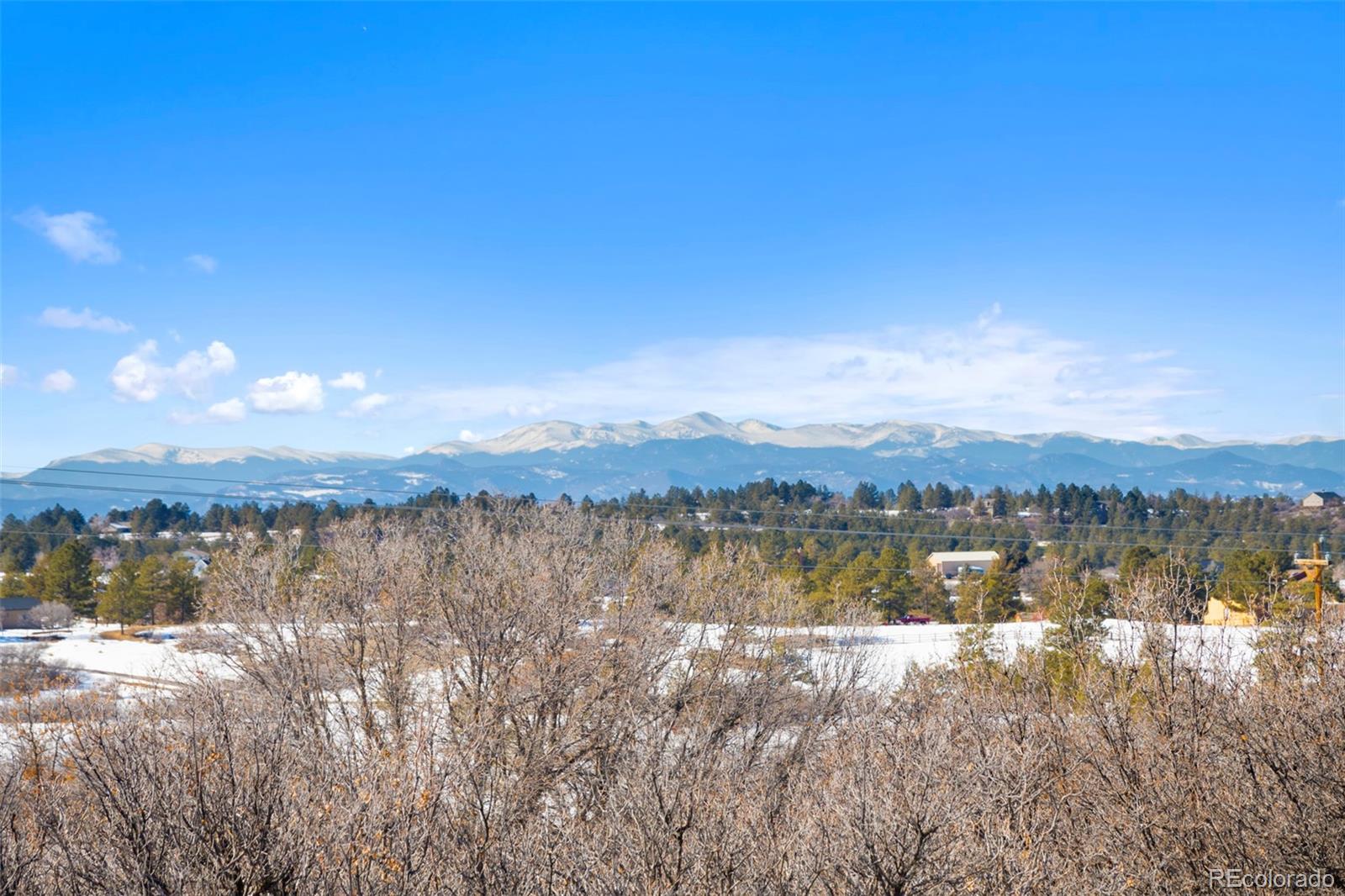 1382 Flintwood Road Franktown, CO 80116 - Photo 7 of 40 a view of lake with mountain