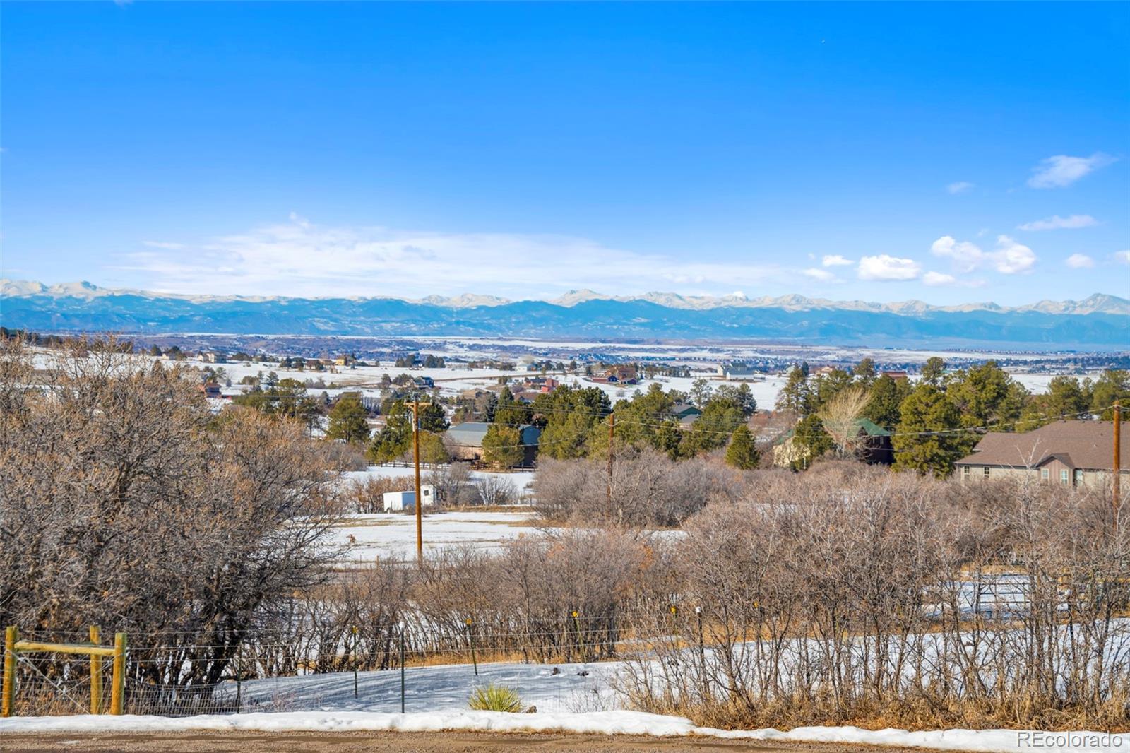 1382 Flintwood Road Franktown, CO 80116 - Photo 8 of 40 a view of lake with mountain in background