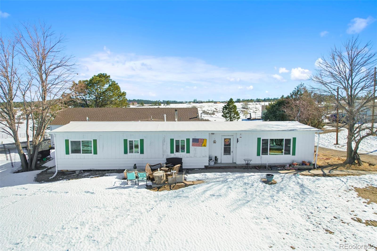 1382 Flintwood Road Franktown, CO 80116 - Photo 9 of 40 a view of a house with snow on the road