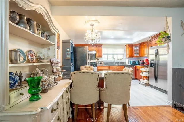 a dining room with furniture a chandelier and wooden floor