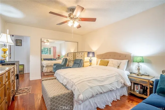 a bedroom with a bed a couch and dresser