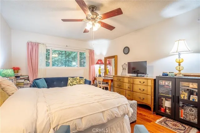 a bedroom with a bed window and a chandelier