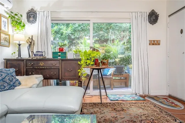 a living room with a couch a table and a potted plant