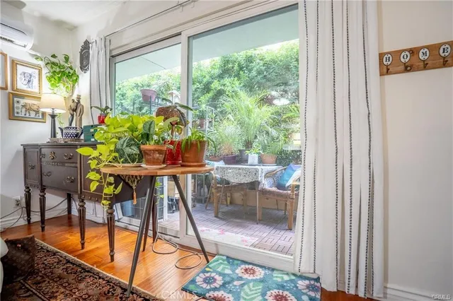 a dining room with furniture and a floor to ceiling window