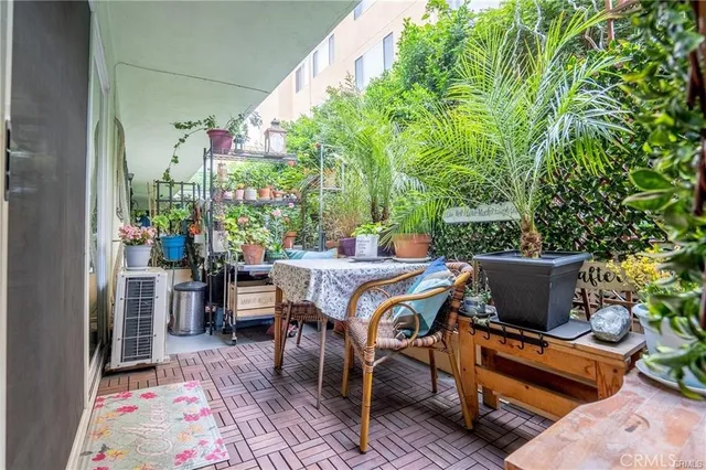 a outdoor dining space with furniture and potted plants