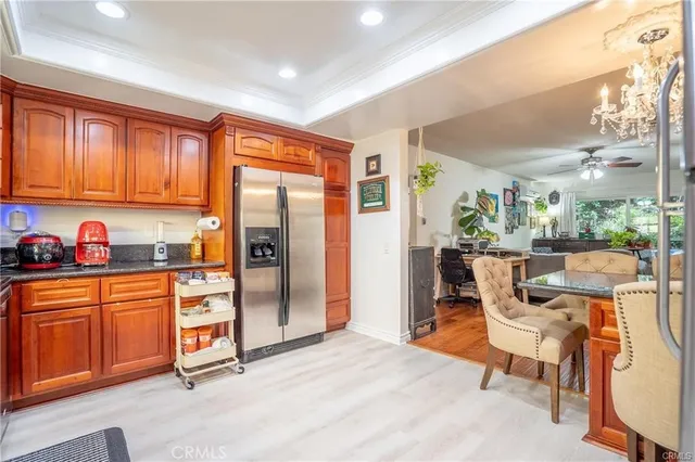 a kitchen with stainless steel appliances granite countertop a refrigerator and a sink