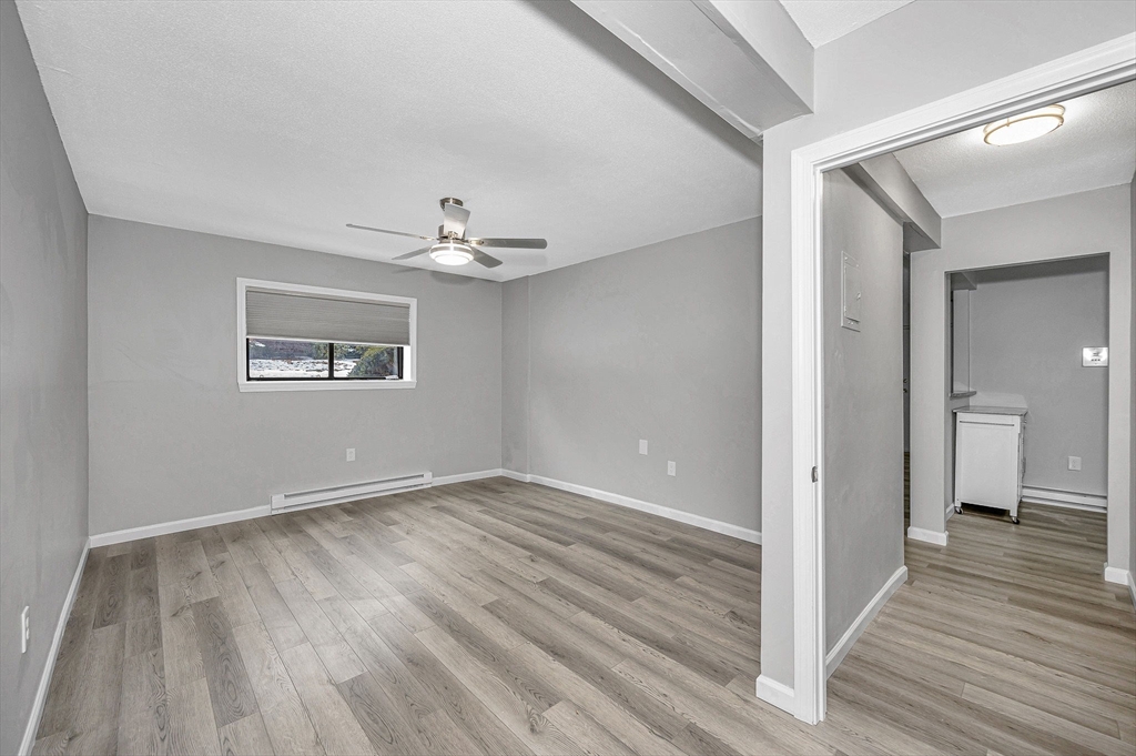 1241 Lawrence Street, Unit 101 Lowell, MA 01852 - Photo 18 of 27 a view of an empty room with wooden floor