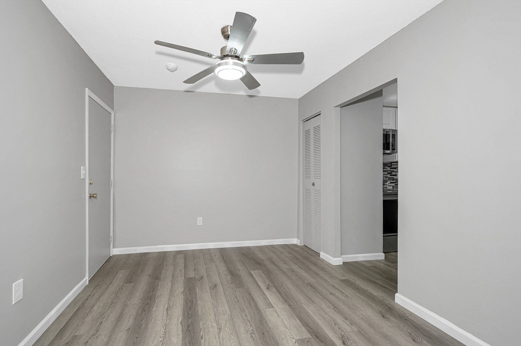 1241 Lawrence Street, Unit 101 Lowell, MA 01852 - Photo 2 of 27 a view of an empty room with wooden floor
