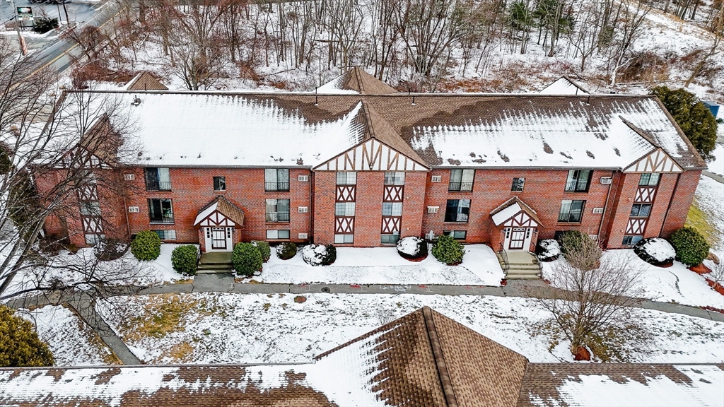 1241 Lawrence Street, Unit 101 Lowell, MA 01852 - Photo 25 of 27 a front view of a house with garden