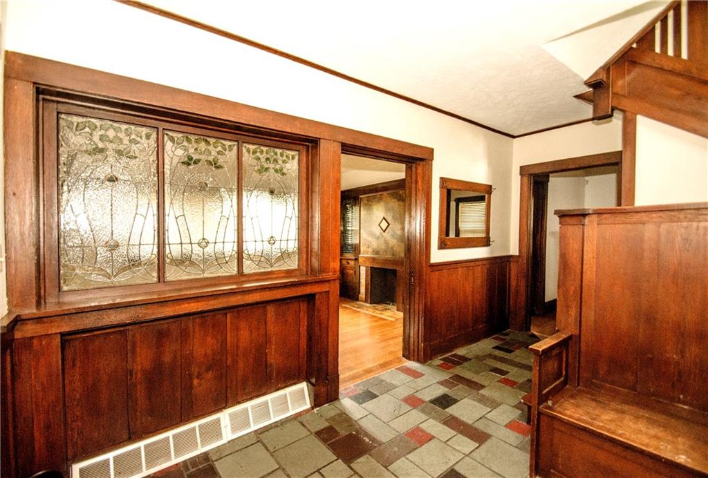 Foyer With Leaded and Stained Glass Panels, Window Seat and Pocket Doors